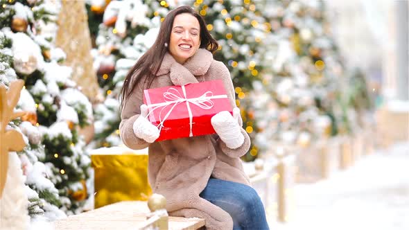 Happy Girl Near Fir-tree Branch in Snow for New Year.