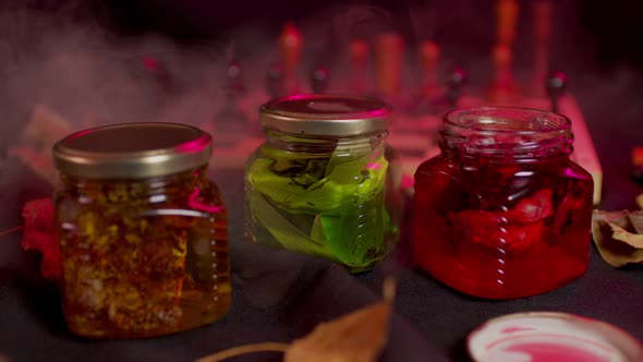 Close Up of Three Jars of Fresh Jam on Black Background with Illuminated and Steam