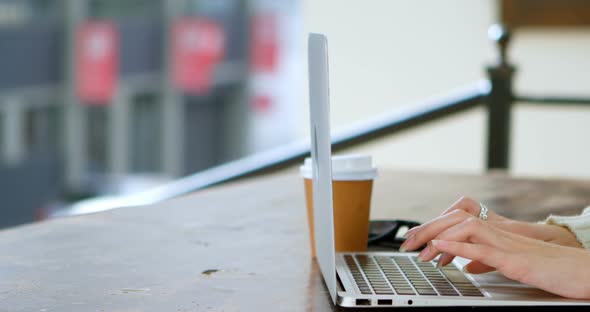 Woman Using Laptop in Cafe 4k