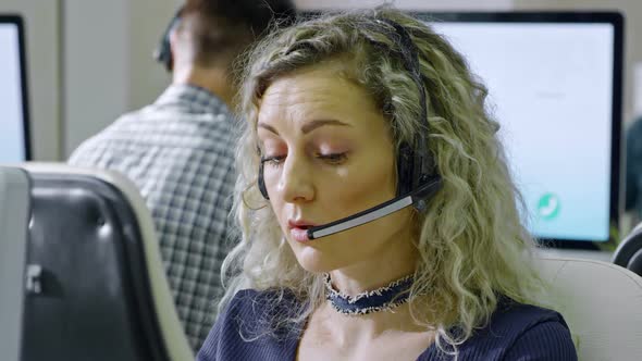 Female Call Centre Operator Talking with Client