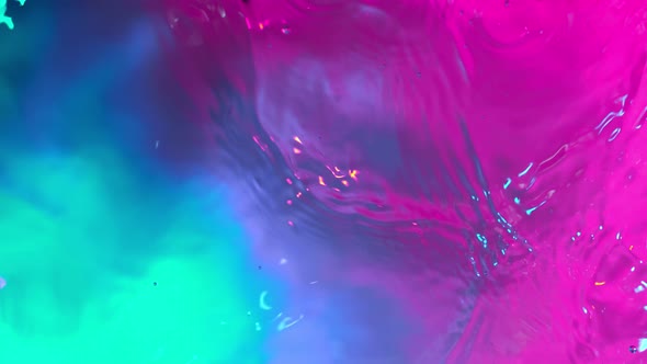 Super Slow Motion Abstract Shot of Swirling Neon Water at 1000fps alt