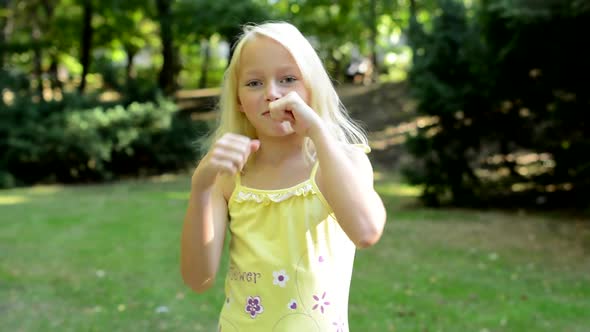 Little Happy Girl Try Box Punch and Resist Poses in the Park