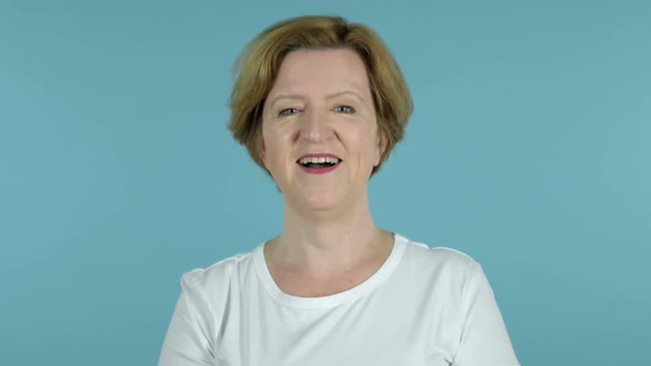 Yes Old Woman Shaking Head to Accept Isolated on Blue Background