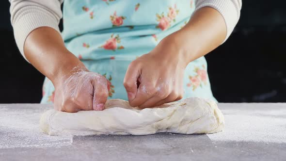 Woman kneading a dough 4k