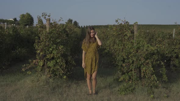 Woman Looking At Camera And Smiling At Vineyard