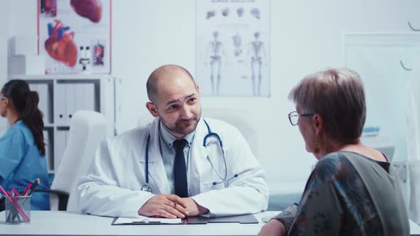 Male Doctor Interviewing an Elderly Woman