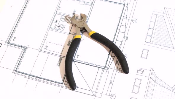 Wire Cutters with Yellow, Gray Handle on Building Plan, Scheme, Rotation