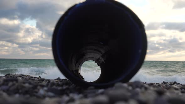 An Plastic Storm Drain Pipe on the the Sea Backgound