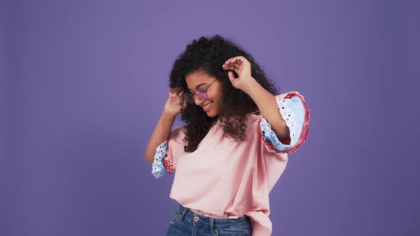 Darkskinned Woman in Sunglasses Colorful Blouse and Jeans