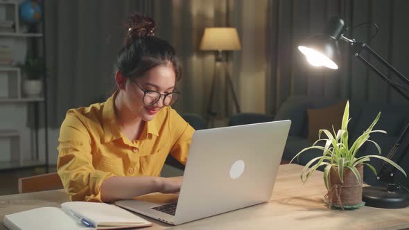 Young Girl Learning Online Or Working From Laptop At Night