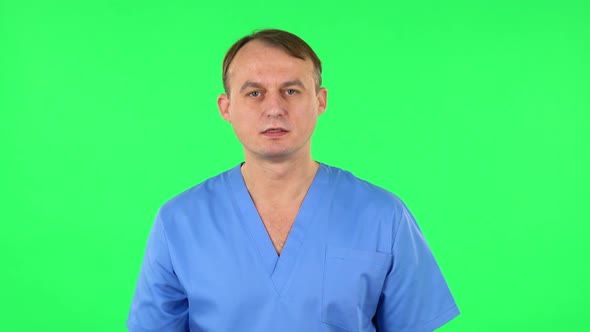 Medical Man Screams Calling Someone on a Green Screen at Studio.