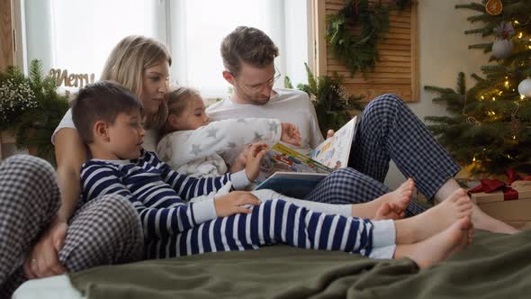 Family reading books at Christmas morning. Shot with RED helium camera in 8K