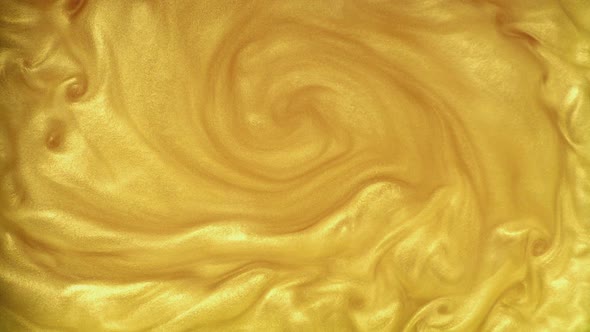 Abstraction of Motion, Swirl of Golden Dust. Abstract Moving Golden Spangles in a Liquid