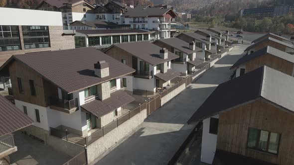 Flying over mountain resort Crystal in Bakuriani. Modern hotel in Georgian mountains