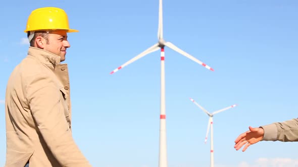 Engineers giving Handshake in Wind Turbine Power Station