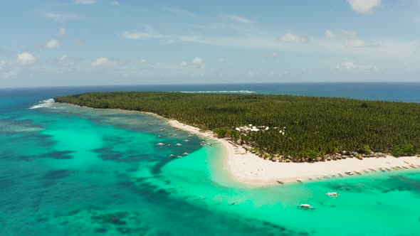 Tropical Daco Island with a Sandy Beach and Tourists