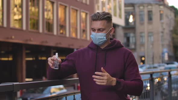 Portrait of Young Man That Sanitizes Alcohol Antiseptic Hands To Protect From the nCov-19