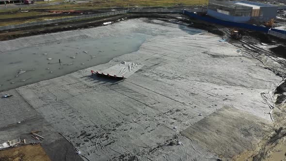 Working People Pull Foil on Open Construction Site Aerial