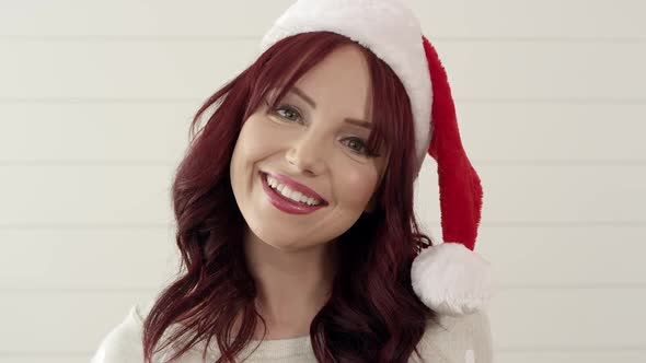 Up close of attractive red headed woman wearing christmas stocking hat