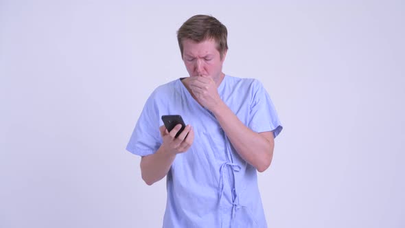 Young Sick Man Patient Coughing While Talking on the Phone