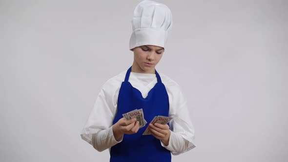 Proud Little Chef Cook Counting Cash Throwing Money Crossing Hands Looking at Camera