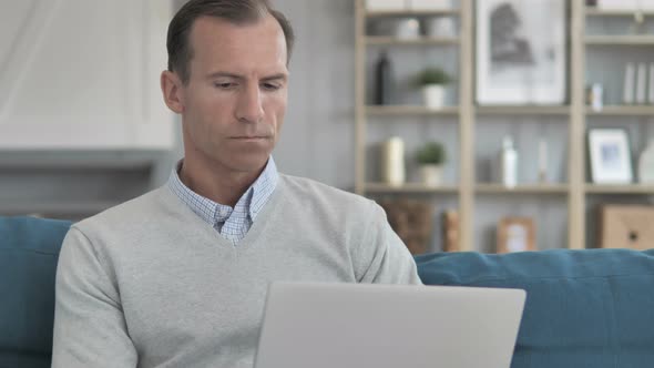 Middle Aged Man Working On Laptop