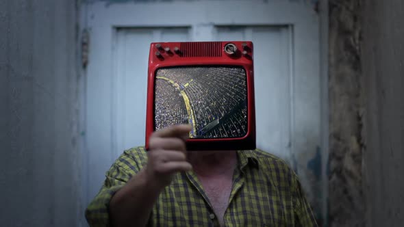 TV headed Man standing with Crowd at a Stadium on the Screen.