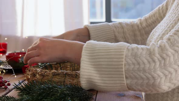 Woman Making Fir Christmas Wreath at Home