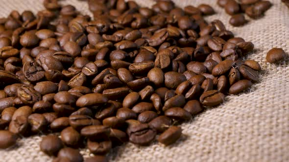 Roasted coffee beans. Slow motion of arabica coffee seeds falling