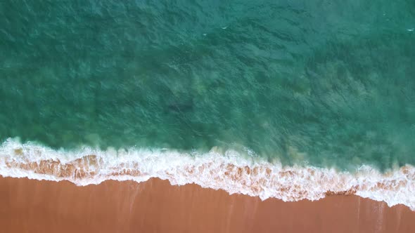 Top View of the sea surface Waves crashing Foaming and Splashing in the Ocean Slow motion