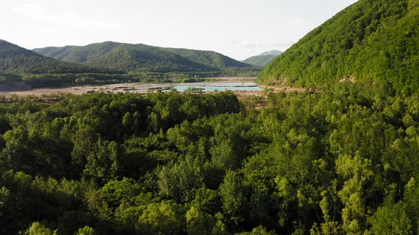 Drone View of a Dam with a Turquoise Lake