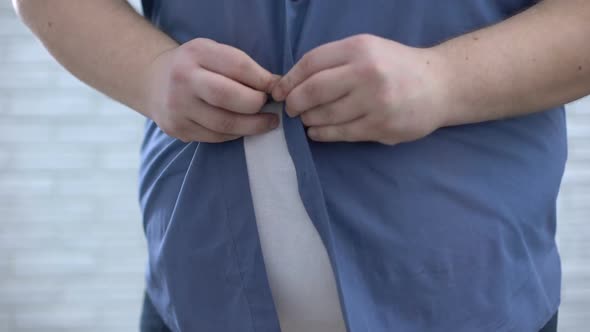 Obese Male Buttoning Up Blue Shirt, Weight Loss Process, Hormonal Disorder