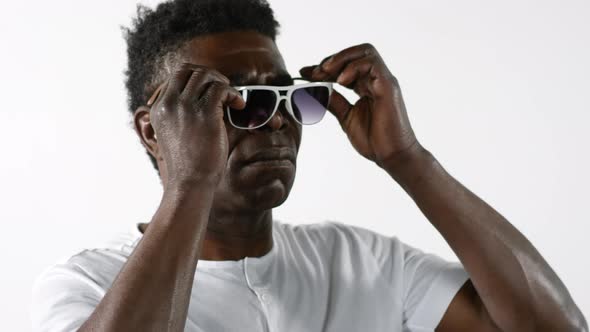 Cool African Man Putting on Trendy Sunglasses