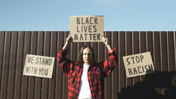 Poster BLACK LIVES MATTER in hands of woman. Stop Racism concept.