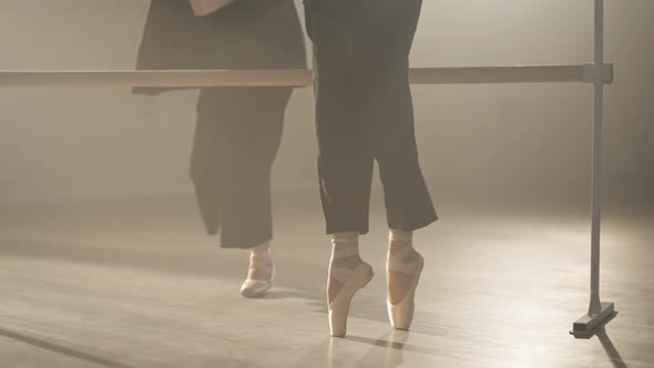 Camera Moves Up From Female Feet in Pointes on Tiptoes to Confident Slim Ballerinas Rehearsing at