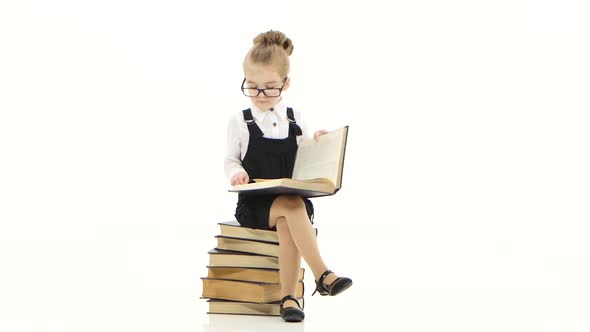 Clever Little Girl Is Reading Big Book on White Background