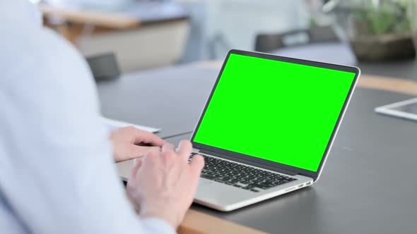 Man in Glasses Using Laptop with Chroma Screen