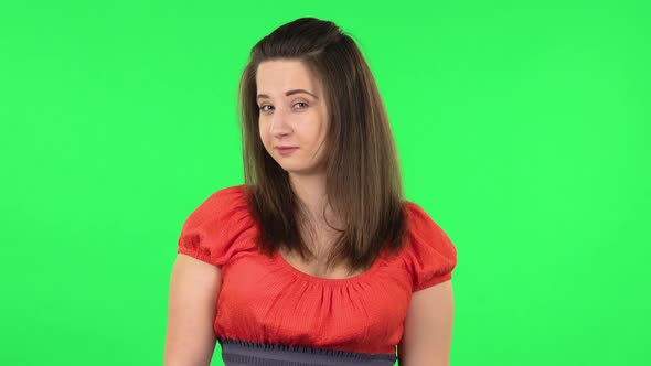 Portrait of Cute Girl Coquettishly Smiling While Looking at Camera. Green Screen