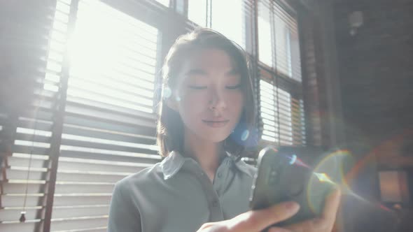 Beautiful Asian Woman Using Smartphone