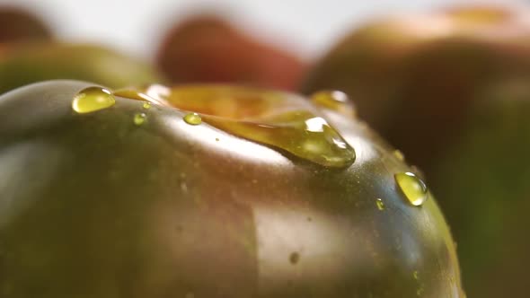 Sparkling splash and water drops on ripe green kumato tomato