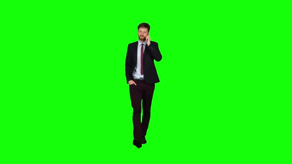 Businessman Walks Down the Street, Puts His Hand in His Pocket and Waves. Green Screen