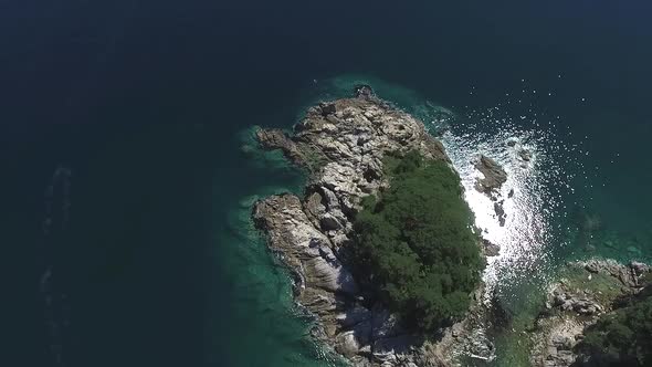 Aerial Over Small Island Covered with Tropical Rainforest Stone Shore Belt Around Woods