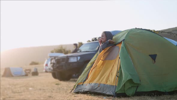 Young Woman Wakes Up and Comes Out From Tourist Tent and Stretches