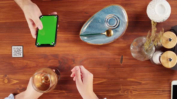 Woman Using Smartphone with Chroma Green Screen Top View Online Menu in Cafe