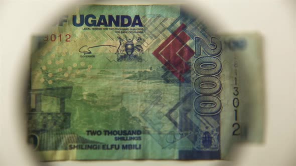 Two thousand Ugandan shillings and a magnifying glass.