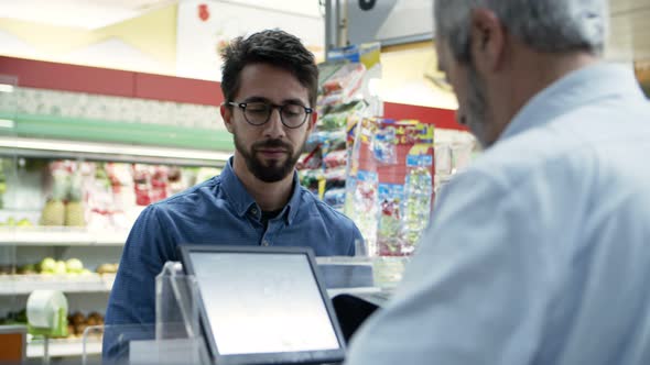 Man Paying with Credit Card in Store