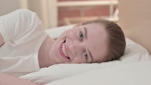 Cheerful Redhead Young Woman Smiling in Bed 