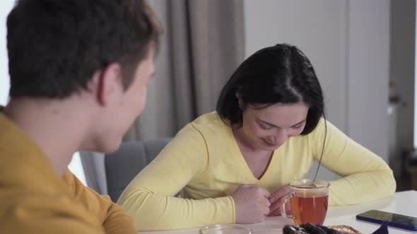 Cheerful Brunette Caucasian Woman Laughing As Listening To Teenage Son. Happy Parent Spending