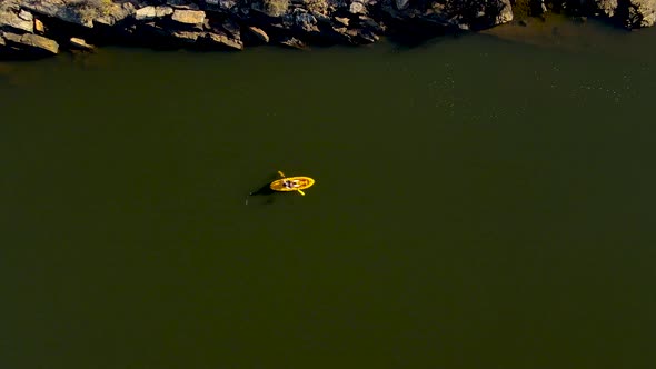 Aerial view woman on yellow kayak, Western Cape, South Africa.