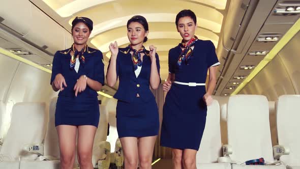 Cabin Crew Dancing with Joy in Airplane